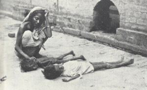 Mother is moaning over her dead child due to a food shortage.